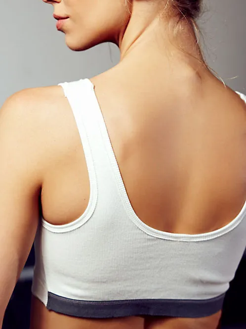 Solid colour polyester fibre sports bra in Black, Grey, Pink, or White for gym and yoga support
