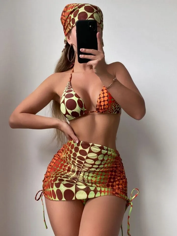Printed split bikini set with chest pad, shorts, skirt, and headband in polyester on woman