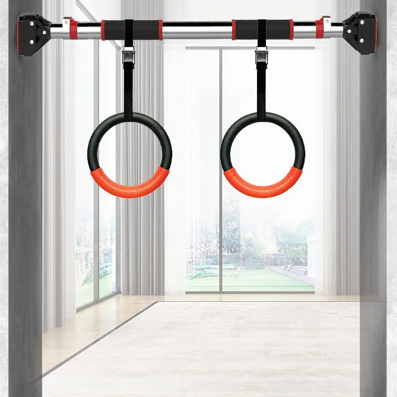 Black rubber encapsulated gymnastics training rings with ropes and gloves on indoor floor