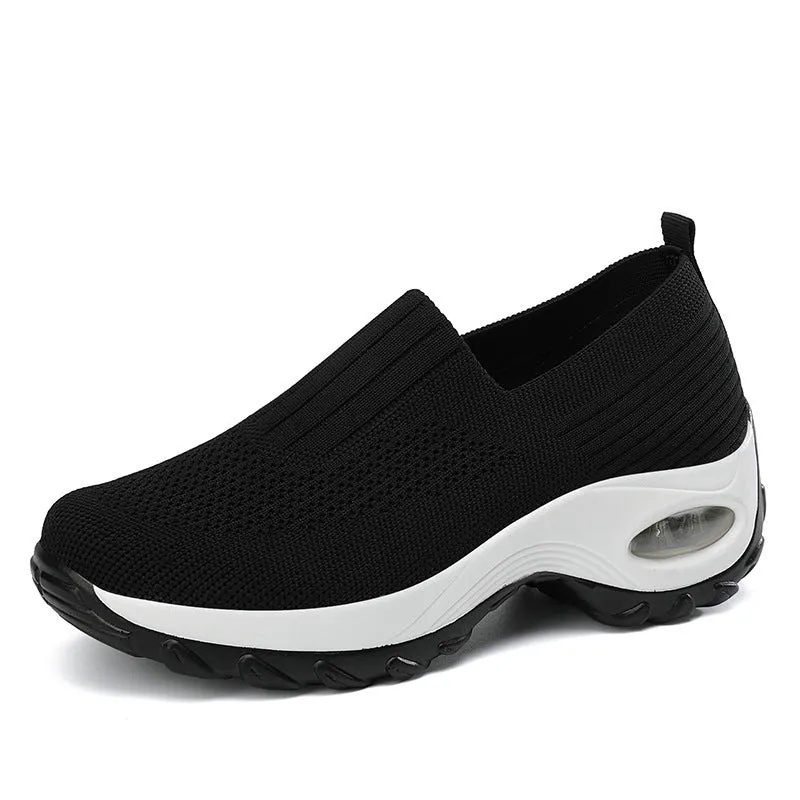 Women's mesh sports shoes in black, side view, showing breathable upper, thick bottom sole, and slip-on design