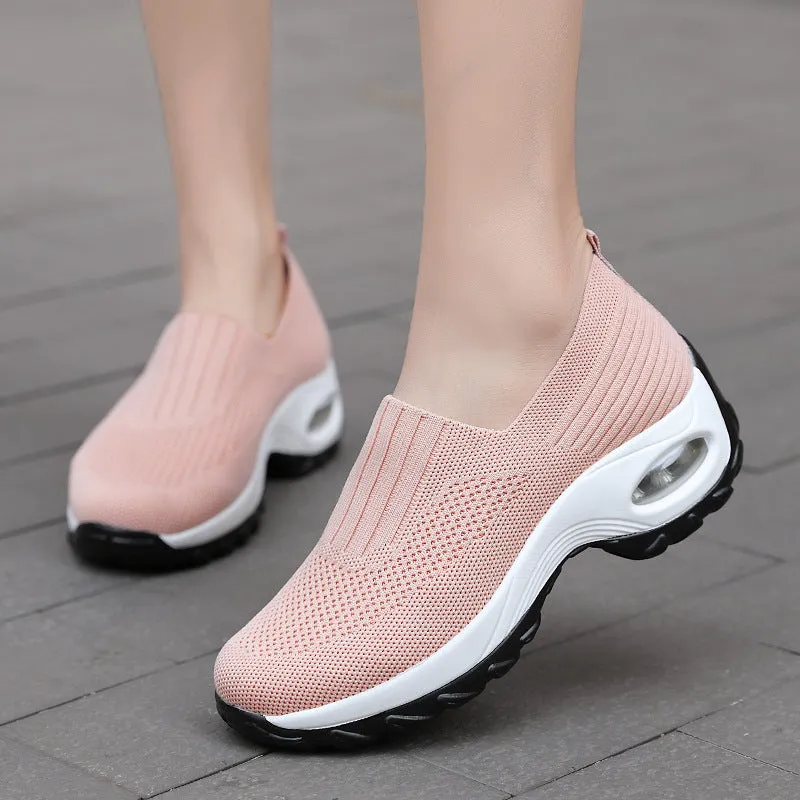 Women's mesh sports shoes in black, side view, showing breathable upper, thick bottom sole, and slip-on design