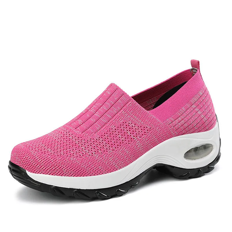 Women's mesh sports shoes in black, side view, showing breathable upper, thick bottom sole, and slip-on design