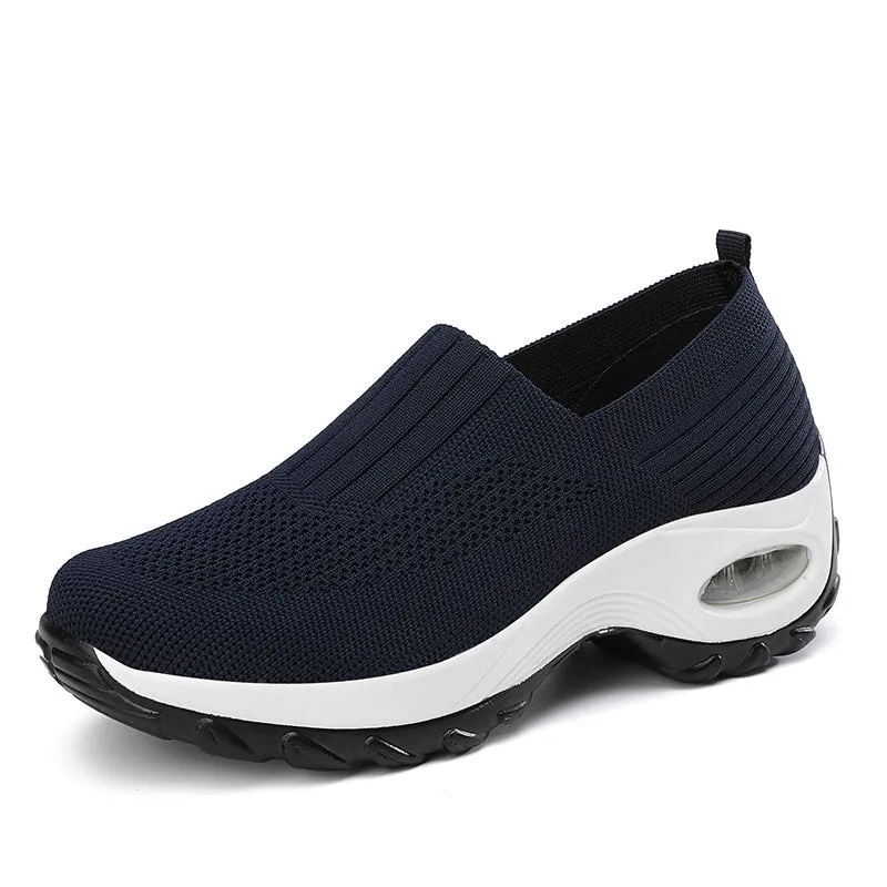 Women's mesh sports shoes in black, side view, showing breathable upper, thick bottom sole, and slip-on design