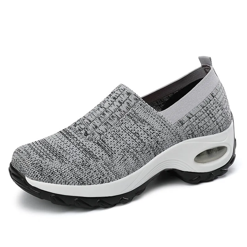 Women's mesh sports shoes in black, side view, showing breathable upper, thick bottom sole, and slip-on design
