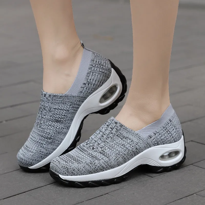 Women's mesh sports shoes in black, side view, showing breathable upper, thick bottom sole, and slip-on design