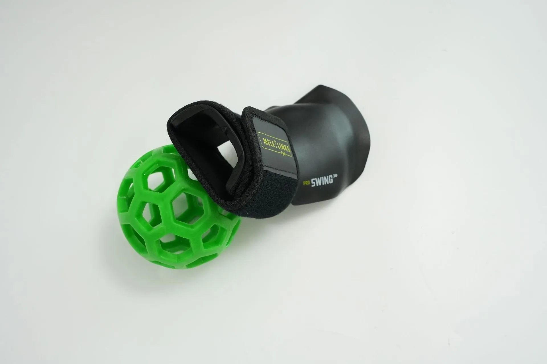 Golf swing trainer arm bracket wrist holder with PU foam fabric suit and green ball on white background