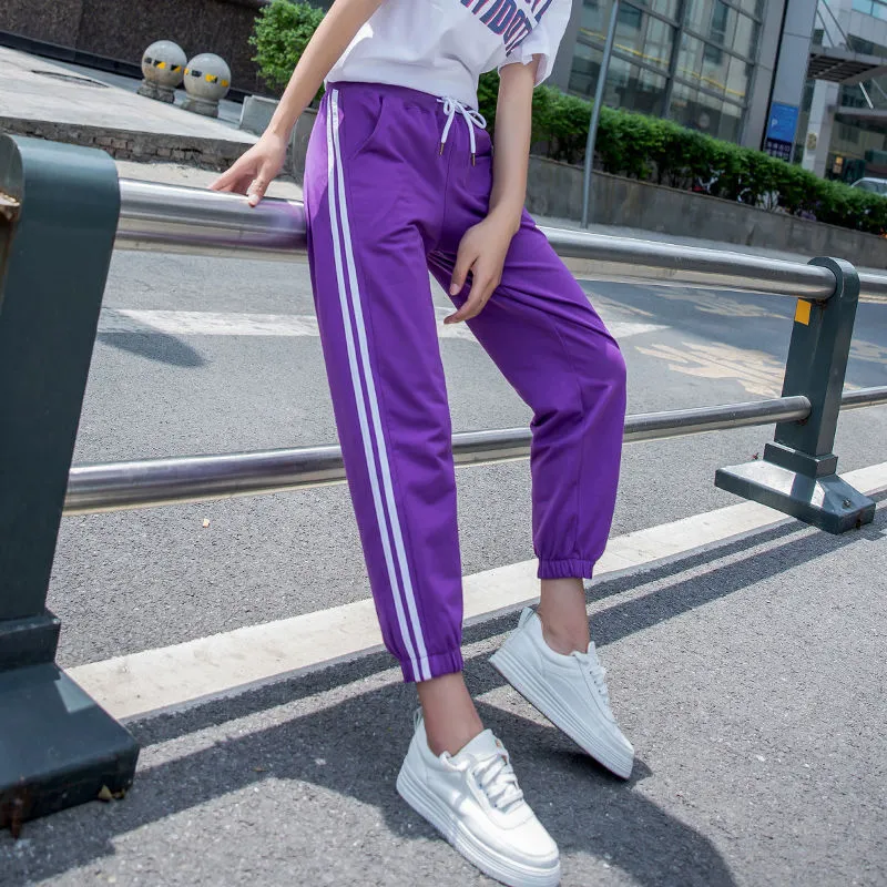Quick-drying women's track pants in solid colour, loose-fit harem style with elastic waist