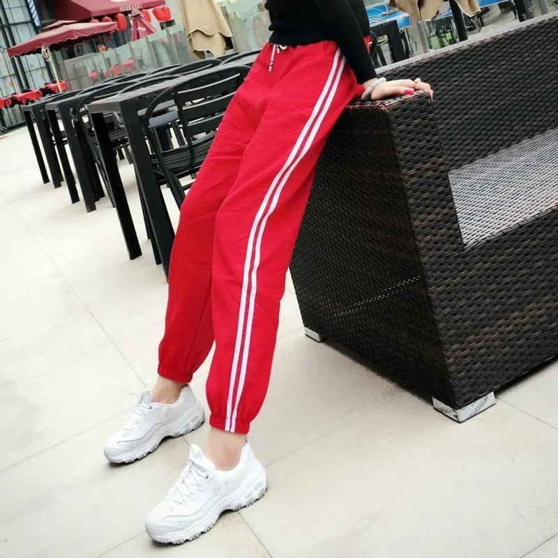 Quick-drying women's track pants in solid colour, loose-fit harem style with elastic waist