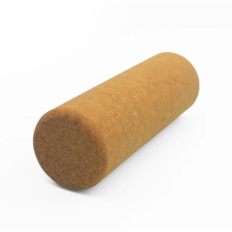 Cork yoga wand cylindrical massage roller 30x10cm on light background