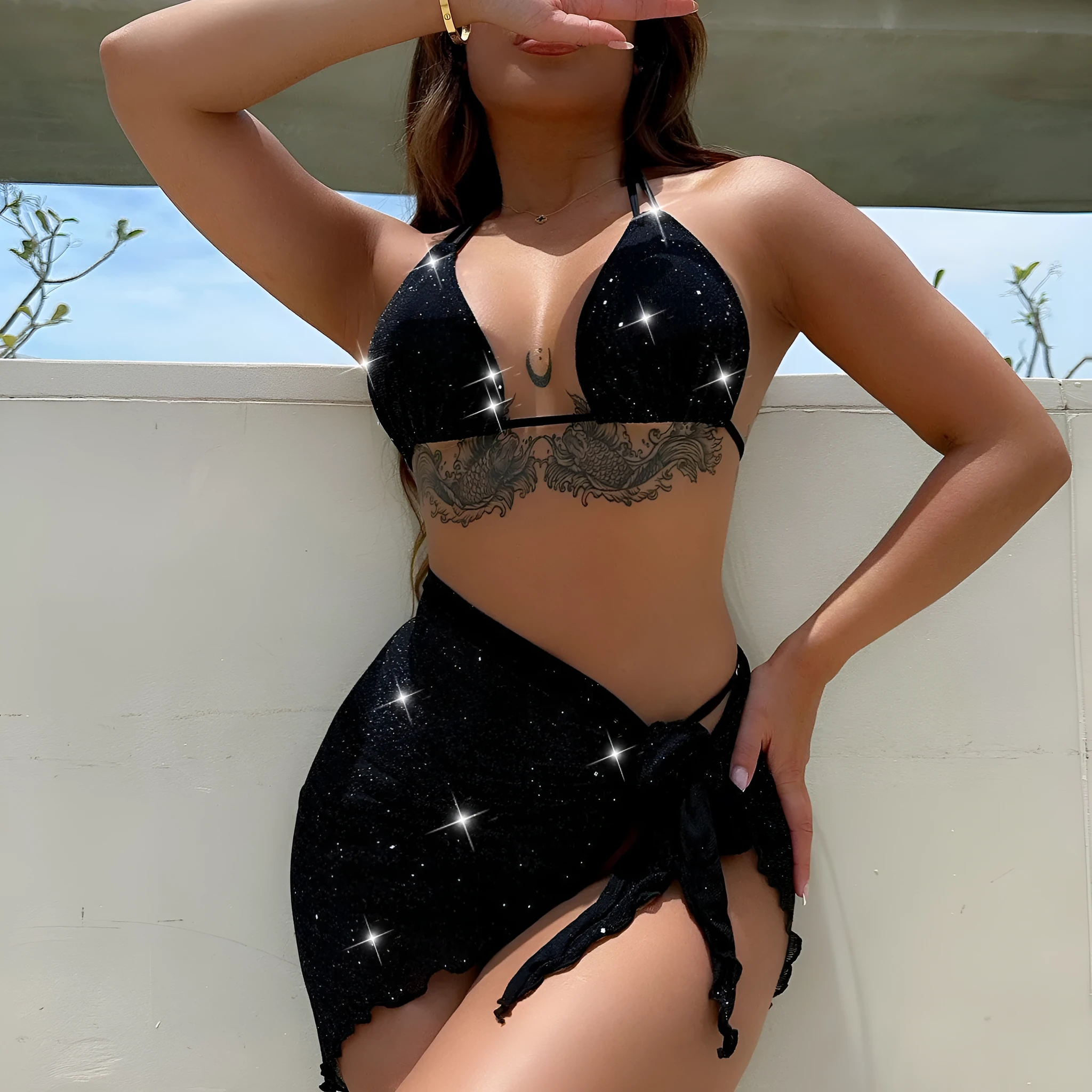 Black three-piece bikini swimsuit set with matching top and shorts on white background
