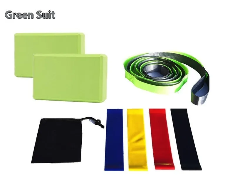 Yoga block eight-piece set with bricks, stretch belt, latex bands, and black storage bag on a floor.