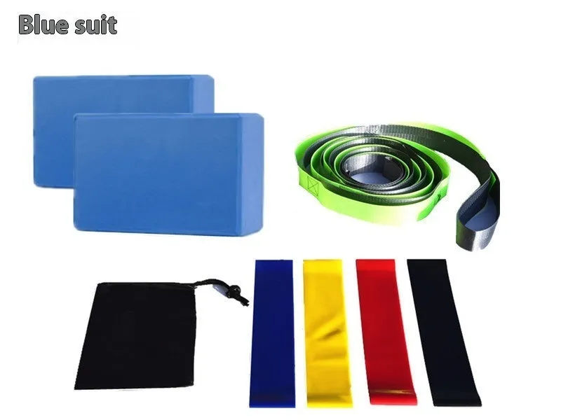 Yoga block eight-piece set with bricks, stretch belt, latex bands, and black storage bag on a floor.