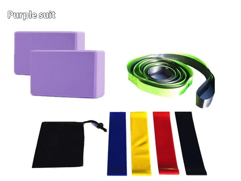 Yoga block eight-piece set with bricks, stretch belt, latex bands, and black storage bag on a floor.