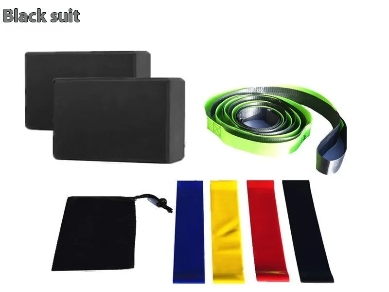 Yoga block eight-piece set with bricks, stretch belt, latex bands, and black storage bag on a floor.