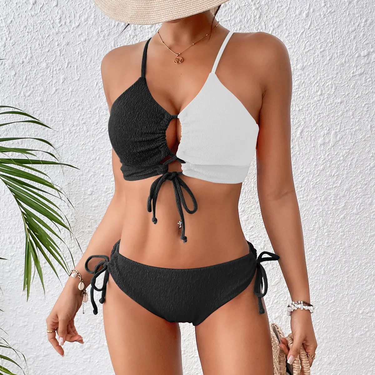 Women's black and white contrast colour cross sling hollow bikini set in polyester, front view