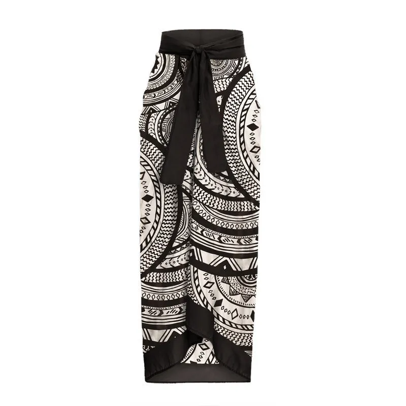 Women's vintage printed deep V-neck one-piece swimsuit with a matching wrap skirt laid flat.