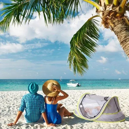Grey children's beach tent with fiberglass frame and Oxford cloth outer, set up on sand