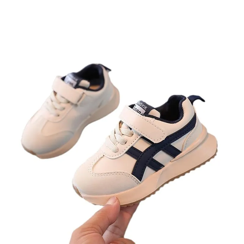 Children's solid-colour sneakers with Velcro strap closure and rubber sole.