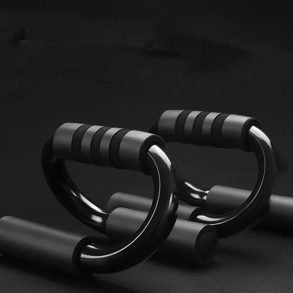Black S shape push-up bracket rack on a home gym floor
