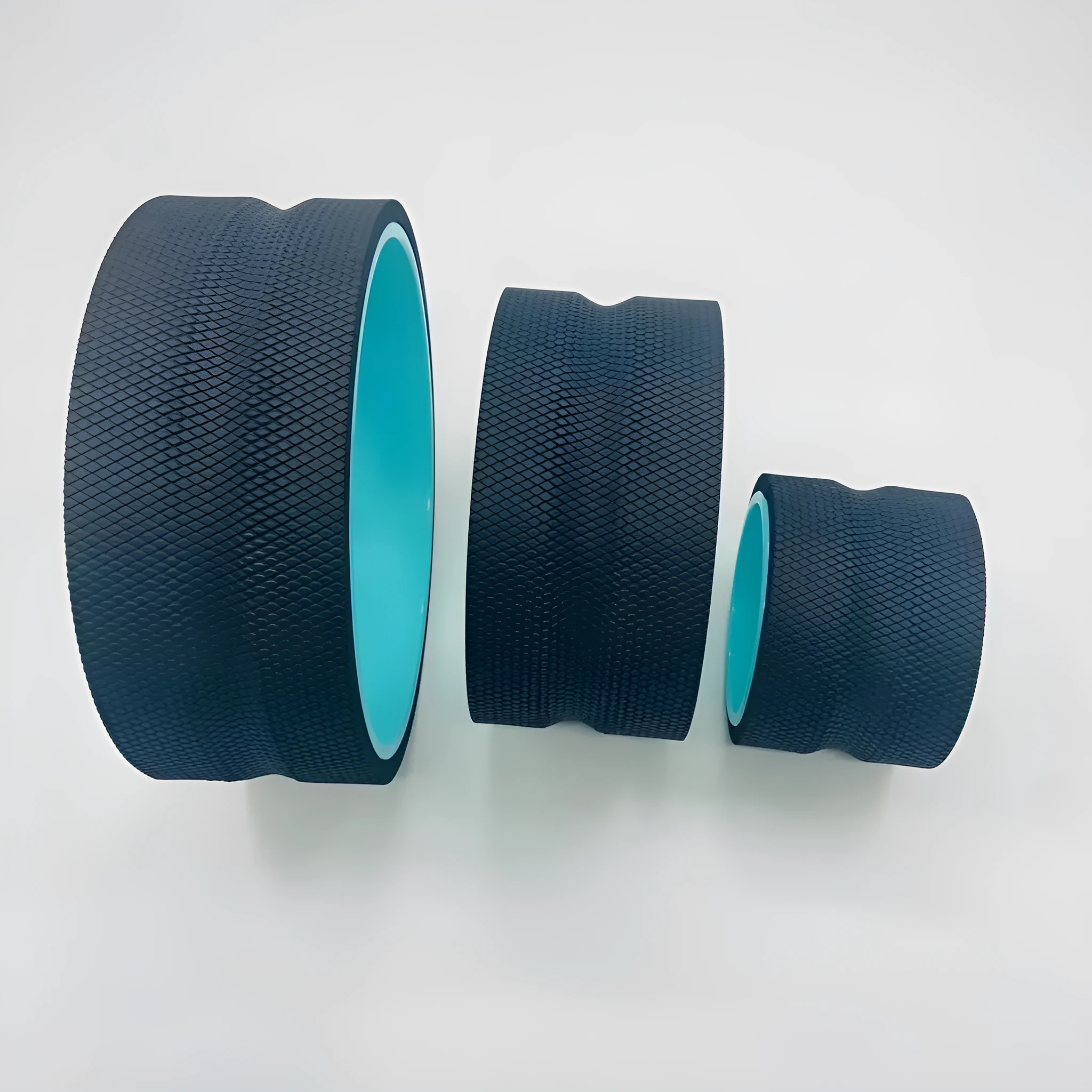 Yoga wheel four-piece set in black with green tube sponge construction and holder