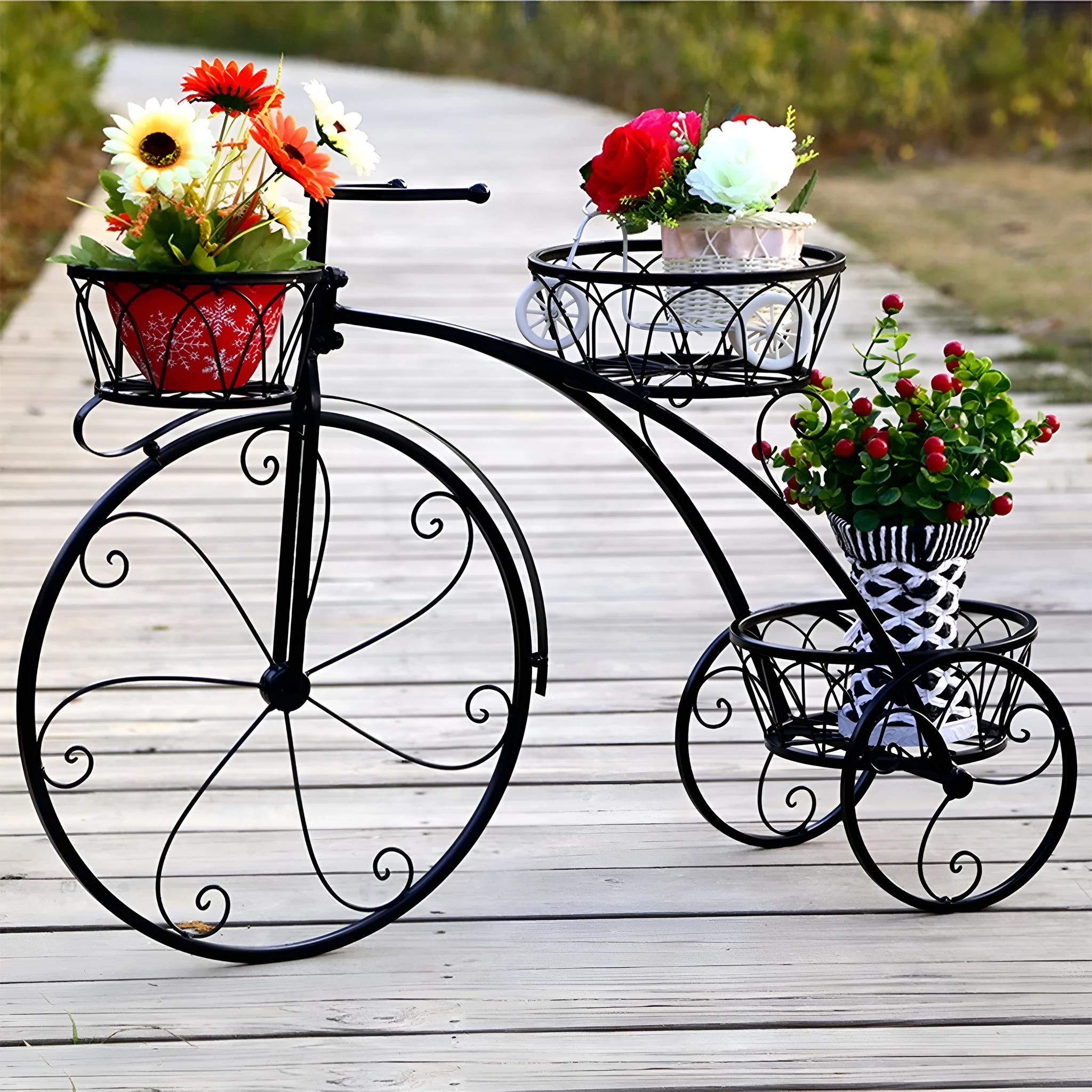 Black wrought iron tricycle plant stand with three round basket tiers and decorative scroll wheels