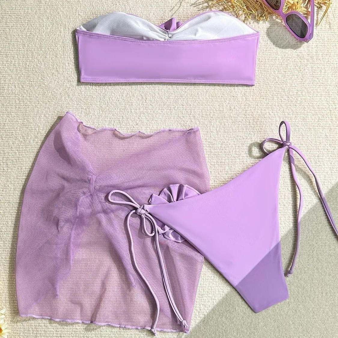 Women's blue tube top swimsuit with a large tied flower, matching pants and skirt.