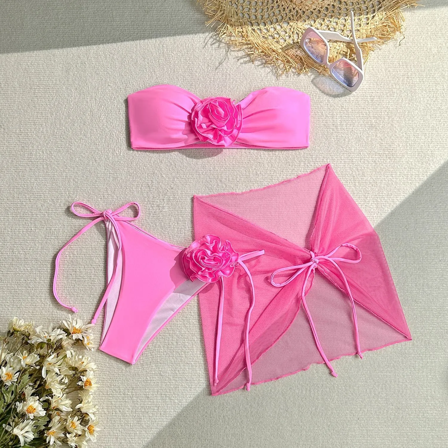 Women's blue tube top swimsuit with a large tied flower, matching pants and skirt.