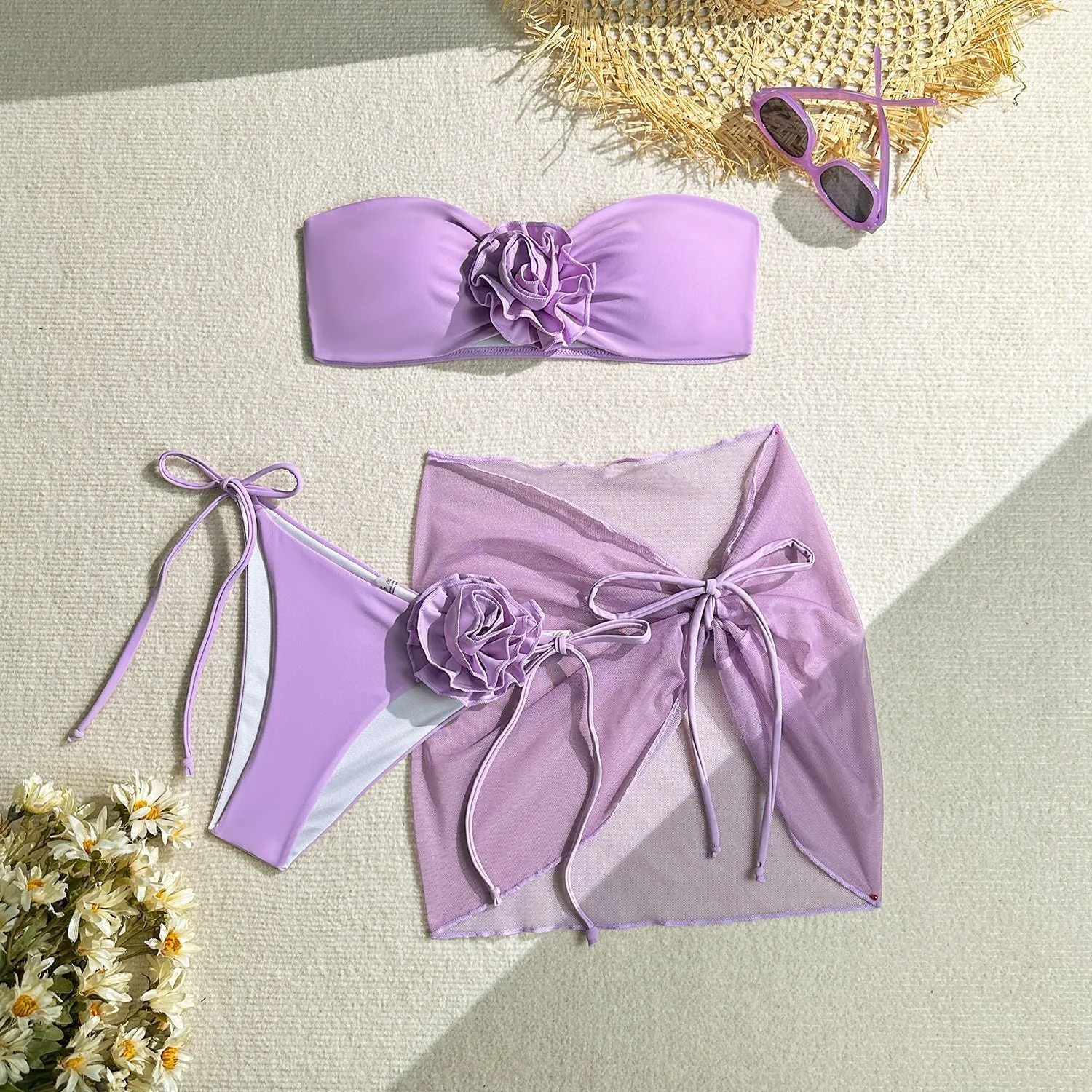 Women's blue tube top swimsuit with a large tied flower, matching pants and skirt.