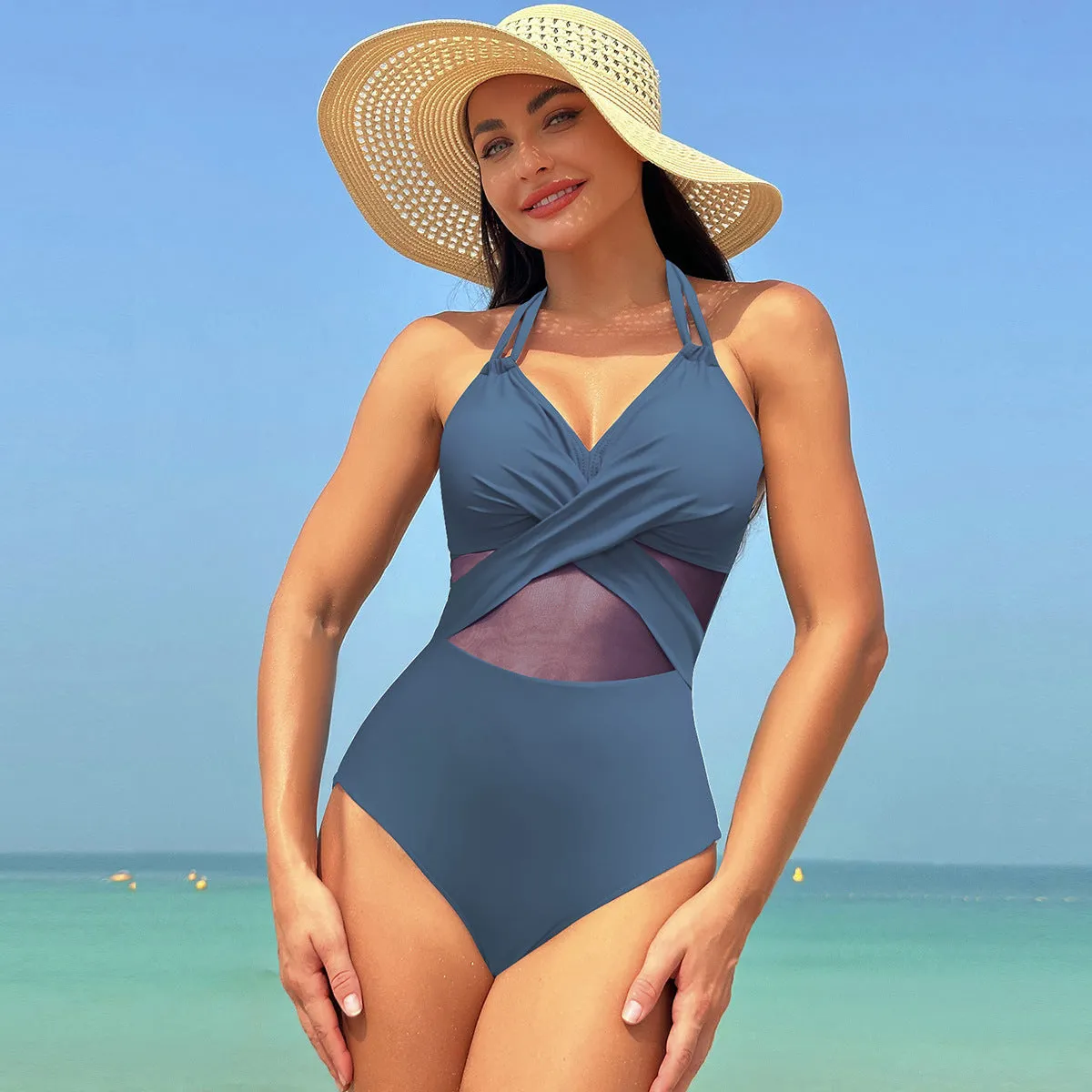 Halter-neck one-piece swimsuit with cross-strap back and mesh detail in solid colour