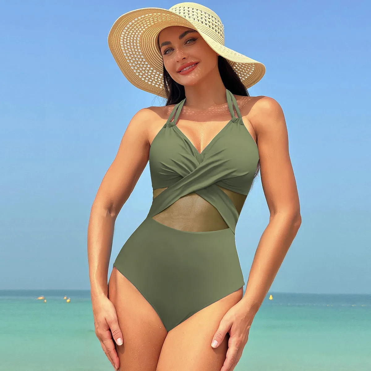 Halter-neck one-piece swimsuit with cross-strap back and mesh detail in solid colour