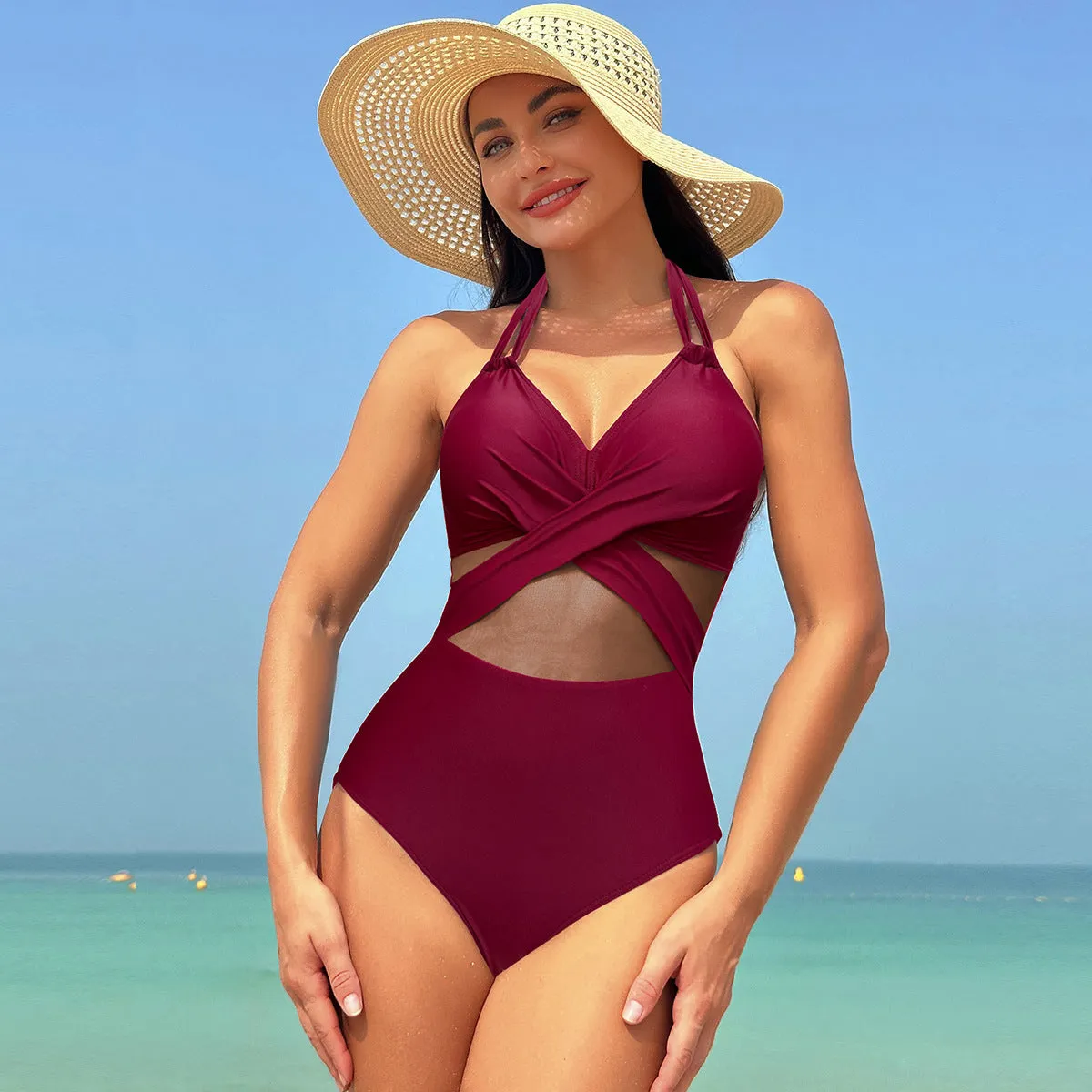 Halter-neck one-piece swimsuit with cross-strap back and mesh detail in solid colour