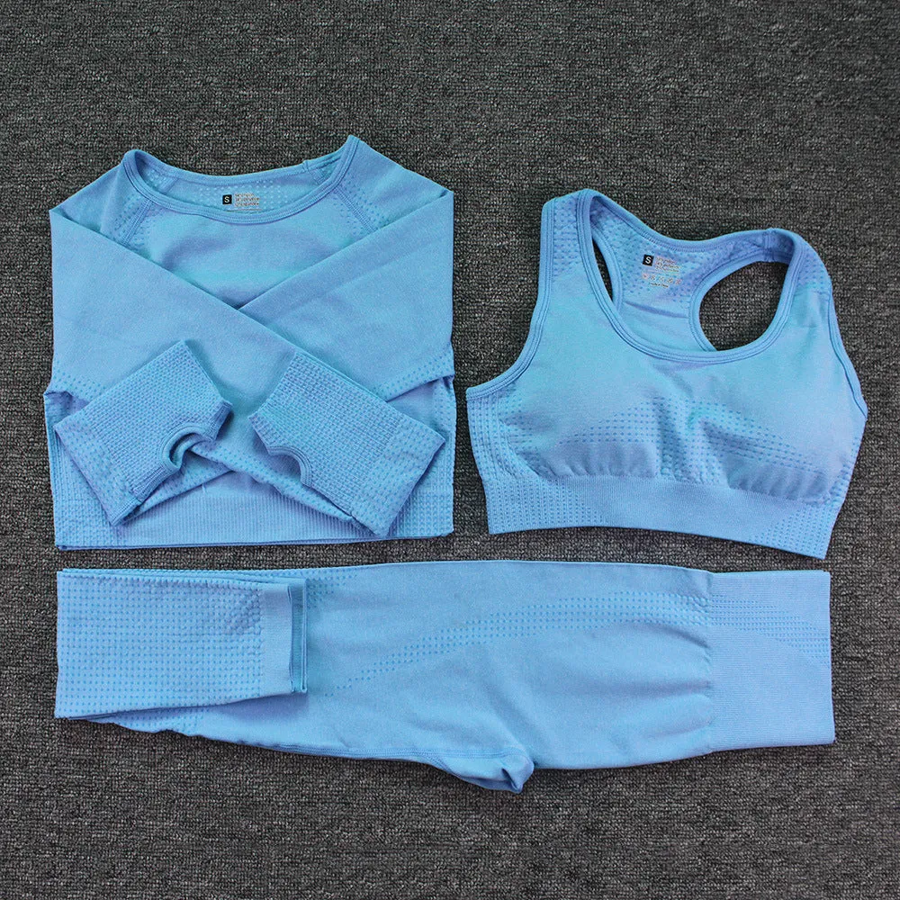 Three-piece yoga clothes set with bra, long sleeve top, and trousers in tight fit nylon blend fabric