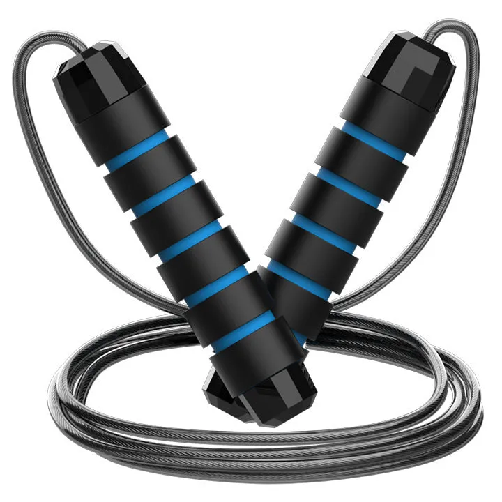 Steel wire jump rope with black PP handle on a dark background for fitness training