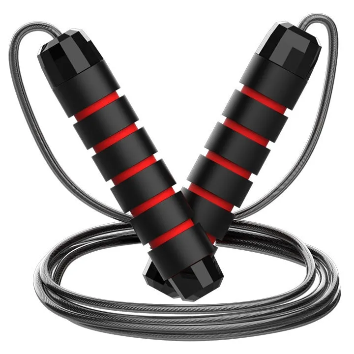 Steel wire jump rope with black PP handle on a dark background for fitness training