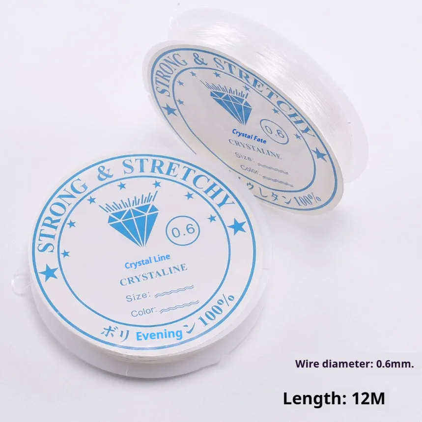 Spool of transparent white elastic cord for jewellery making on a craft table.