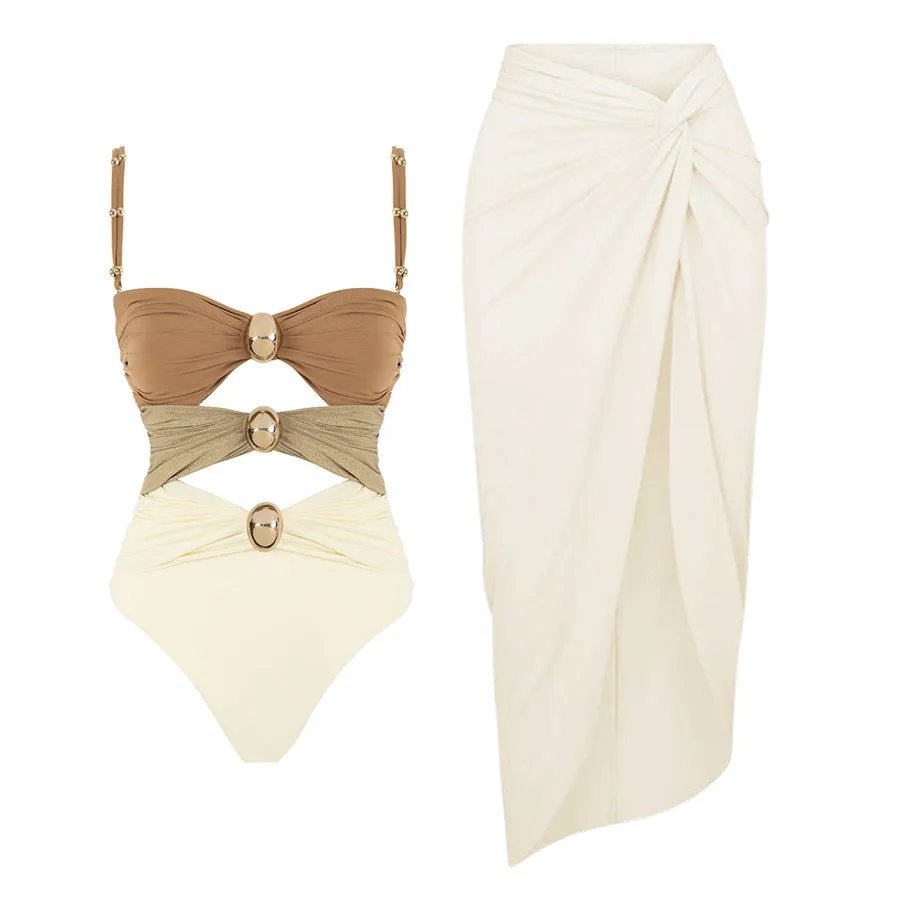 Women's solid colour one-piece swimsuit with matching skirt and gold button detail