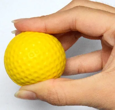 10 yellow PU foam indoor practice golf balls with 41mm diameter on a green surface