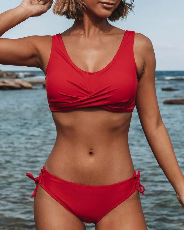 Women's strappy bikini swimsuit in solid colour polyester, front view, available in multiple sizes and colours