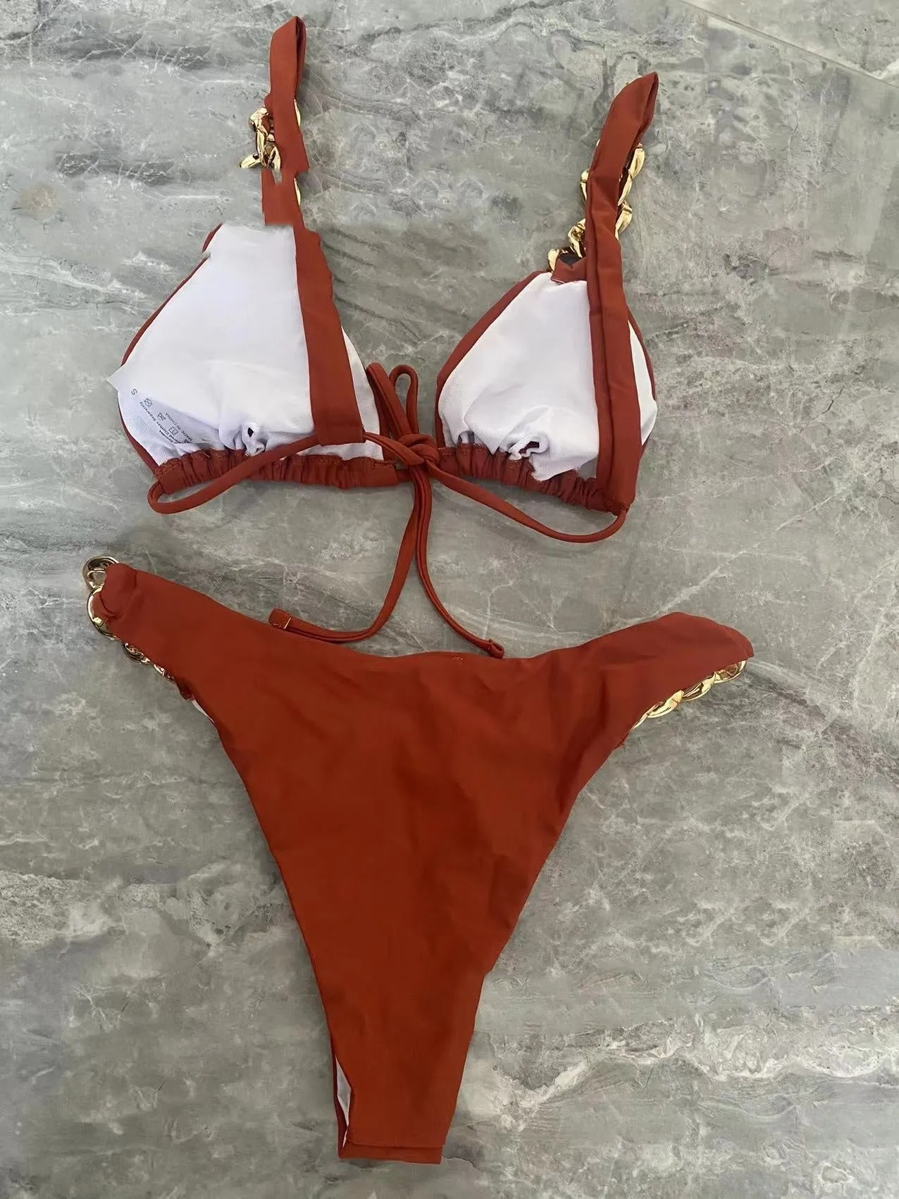 Brown women's tube-top bikini with adjustable ring straps and a split skirt for swimming.