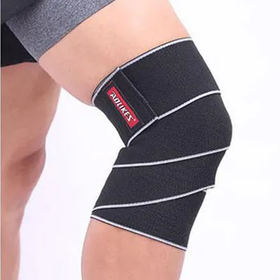 Aolikes orange lifting knee wrap with velcro fastening stretched out for squats