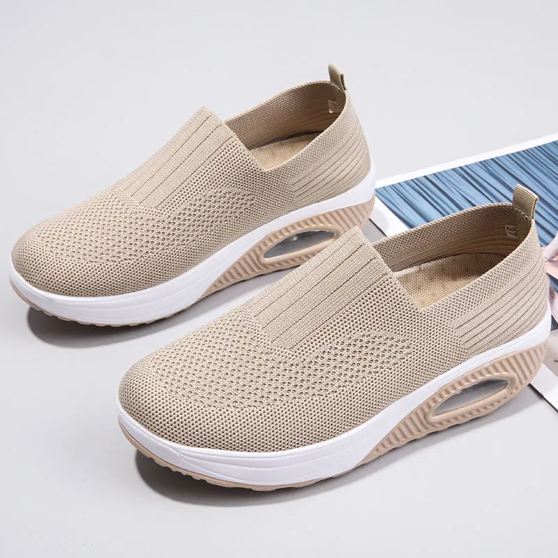 Women's beige casual running shoes with mesh upper and air cushion sole on a white background.