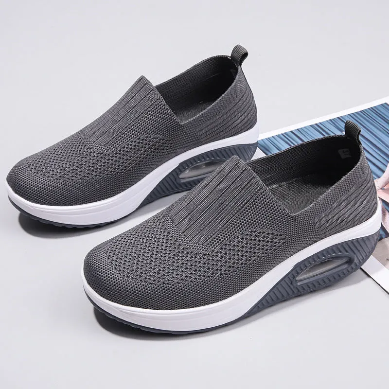 Women's casual mesh running shoes in light grey with round toe and air cushion sole, shown on a foot.