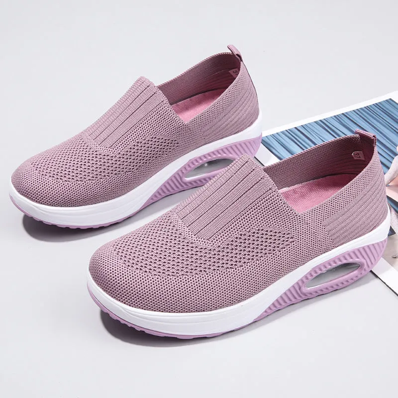 Women's beige casual running shoes with mesh upper and air cushion sole on a white background.