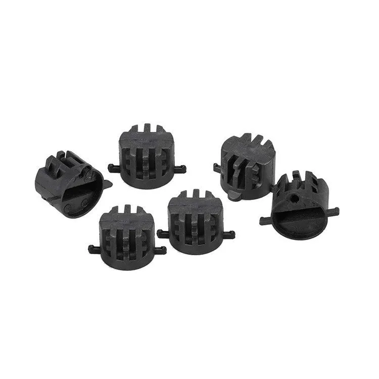 Set of six PVC surfboard G5 tail rudders in round cup design, black colour, on a flat surface