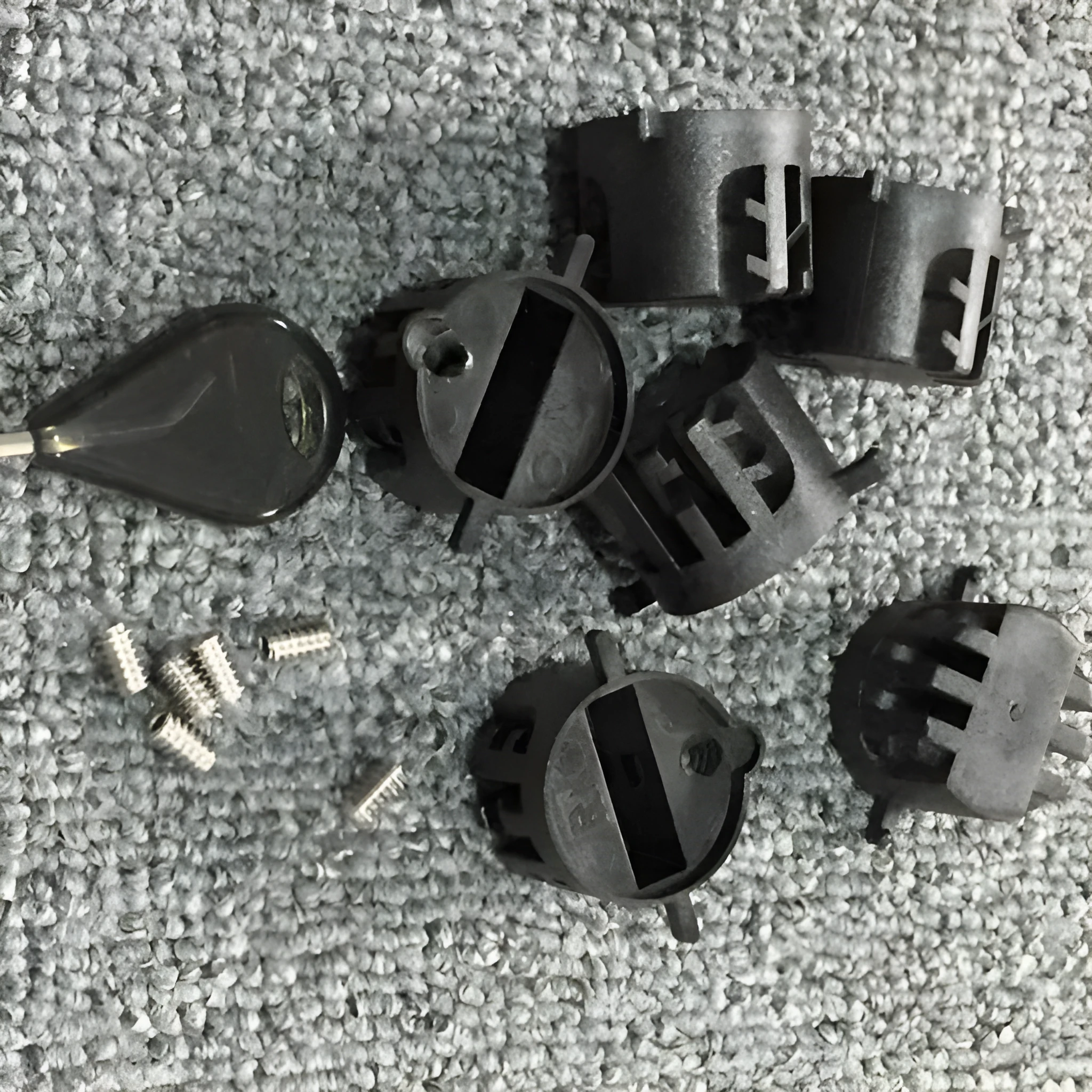 Set of six PVC surfboard G5 tail rudders in round cup design, black colour, on a flat surface
