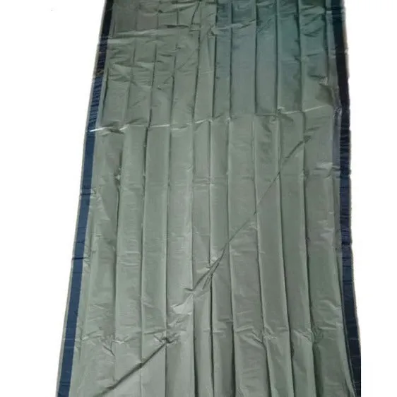Orange aluminium foil emergency sleeping bag with drawstring bag and whistle on ground