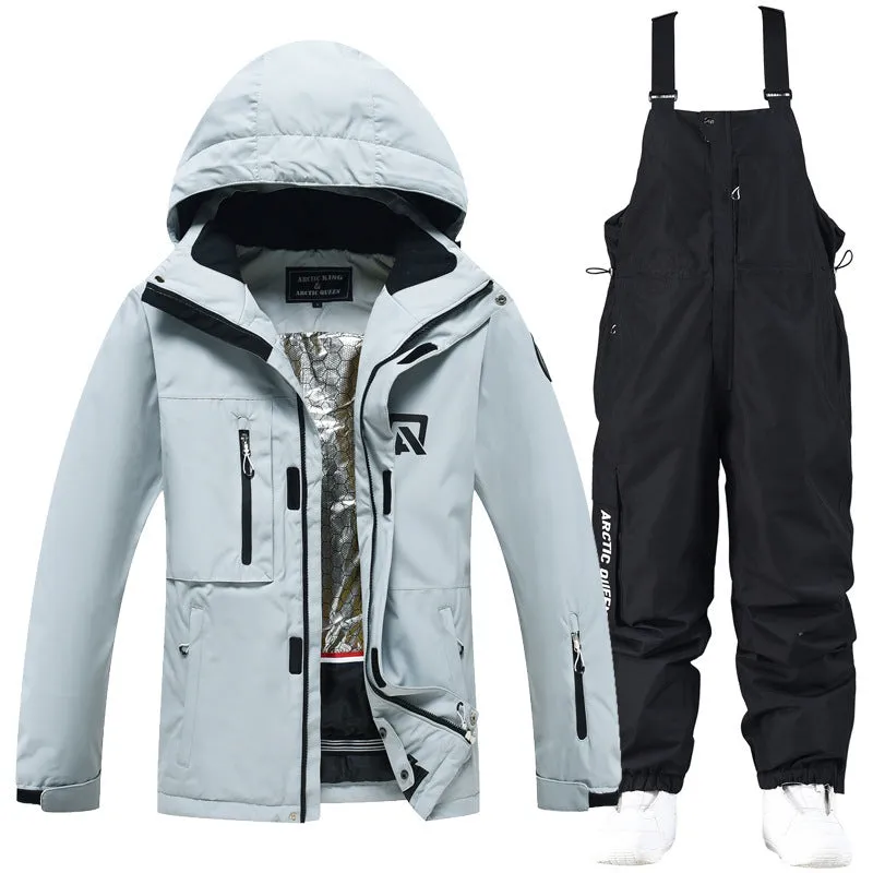 Man and woman modelling a blue and black waterproof ski suit for winter snow sports.