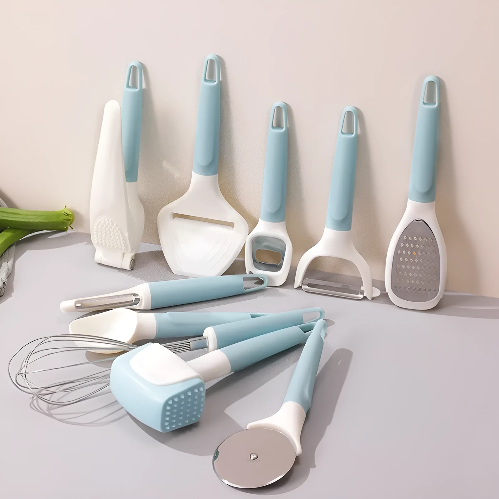 10-piece kitchen gadget set with PP handles and stainless steel inserts including cheese scraper, meat tenderizer, egg beater, and grater on a white background