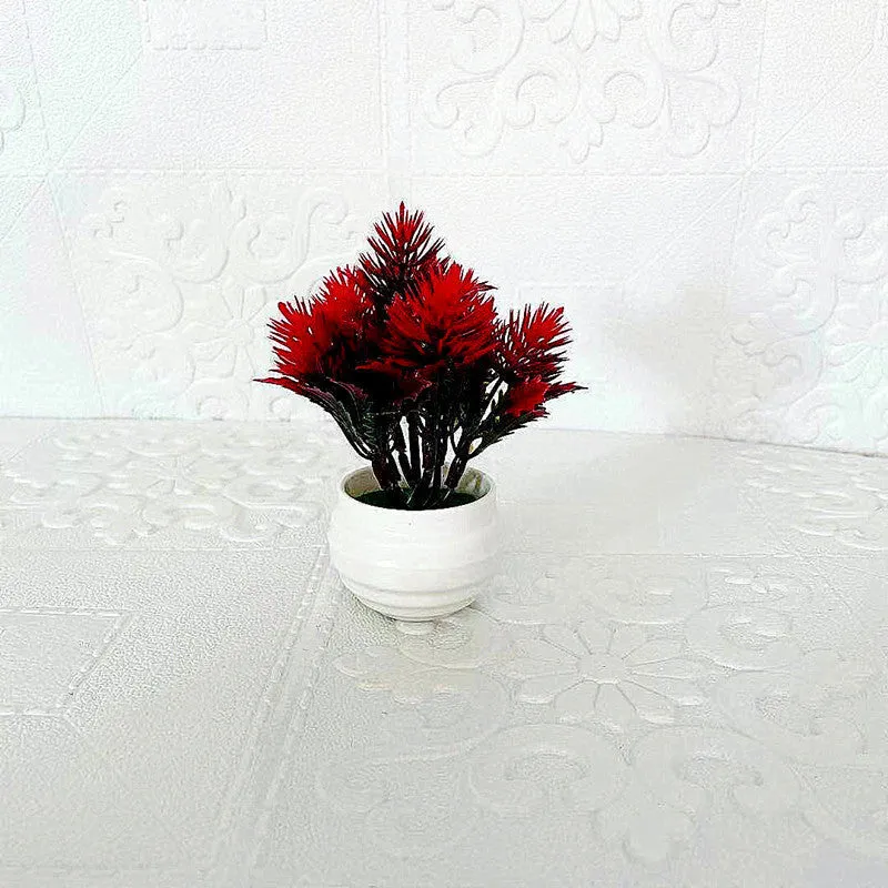 Simulated bonsai potting ornament in green plastic with bonsai shape on white background