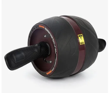 Home abdominal wheel in Black red with PP handle and spring boost mechanism on a flat surface